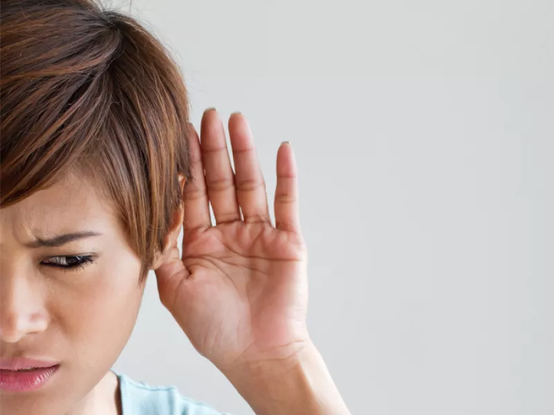 woman with hand to her ear