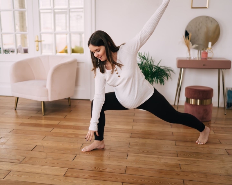 A pregnant woman does yoga at home