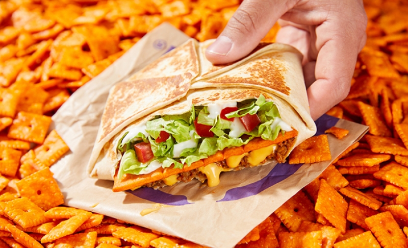 Taco Bell Big Cheez-It Crunchwrap Supreme on a pile of cheez-its