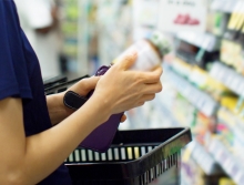 person looking at a vitamin bottle in a store